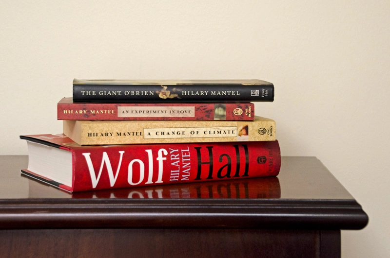 On left, a book cover with a painting of a person with long dark hair; On right, lined paper with handwritten notes.