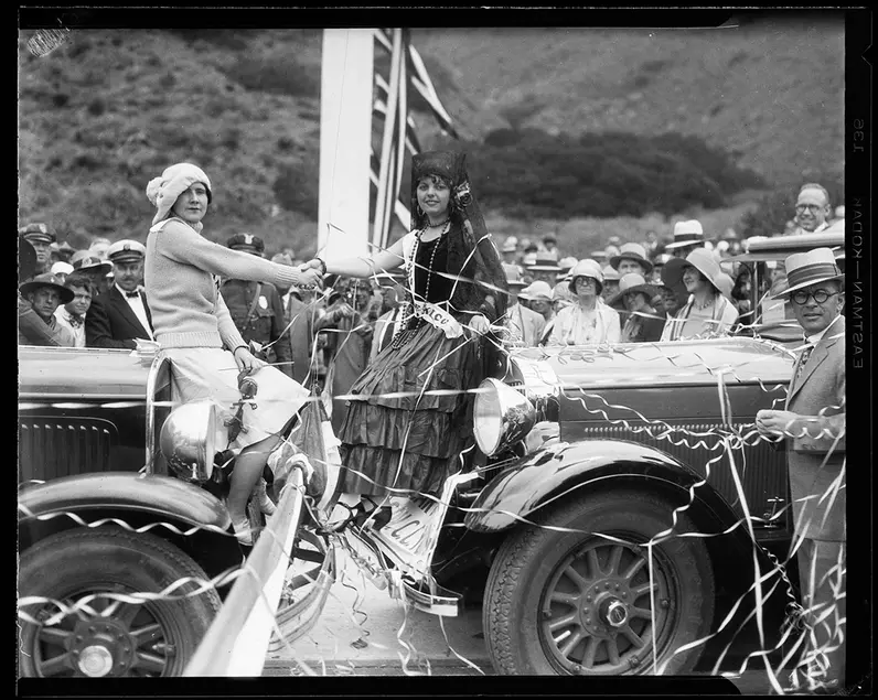 Powell Press Service, Women representing Canada and Mexico shaking hands at the Roosevelt Highway Dedication, Sycamore Canyon, Malibu, June 29, 1929. Ernest Marquez Collection. photCL 555 06 1348