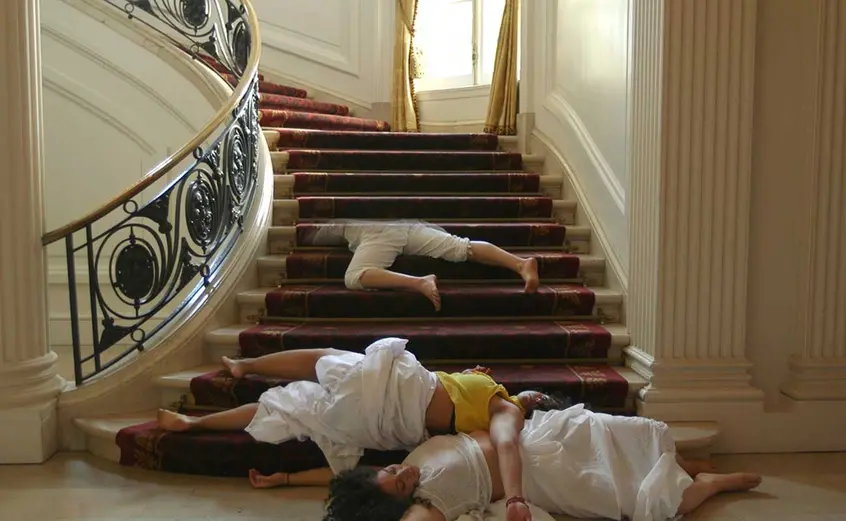 Performers sprawled on staircase