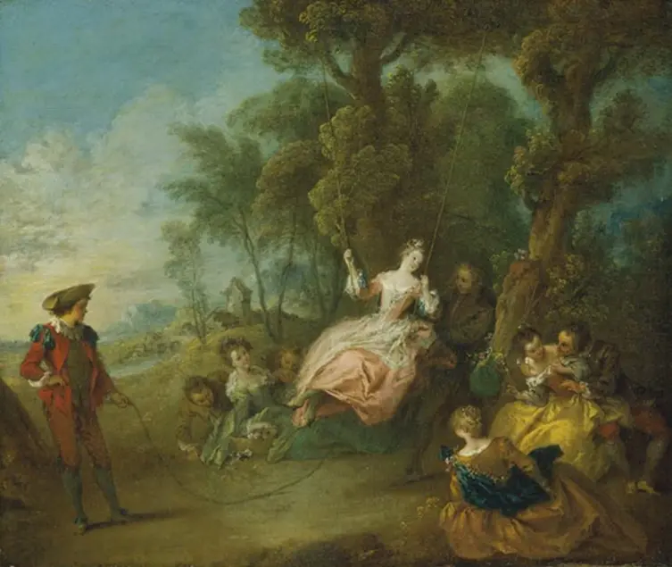 A woman in a flowing white and peach dress sits on a swing hanging from a tree as a person in red holds a rope tied to the bottom of the swing as onlookers site or lay nearby.