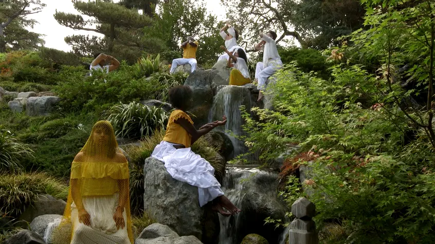 Video still depicting dancers in the Japanese Garden at The Huntington for Apariciones/Apparitions, a video work by Carolina Caycedo. Choreography by Marina Magalhães; cinematography by David de Rozas. Jointly owned by The Huntington Library, Art Collections, and Botanical Gardens and the Vincent Price Art Museum Foundation. Image courtesy of the artist.