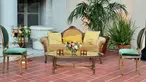 Yellows, golds, and pearl green accented love seat and chairs.