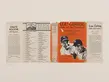 A book jacket on tan paper, an orange front cover depicts black and white photos of baseball player Lou Gherig.