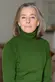 Headshot of Katherine Bucknell wearing a forest green turtleneck.