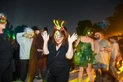 A group of people in costumes on a dance floor.