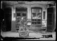 Unknown photographer, Young store clerk sitting in front of shops selling poultry and clothing, Old Chinatown, Los Angeles, ca. 1900. The Huntington Library, Art Museum, and Botanical Gardens.
