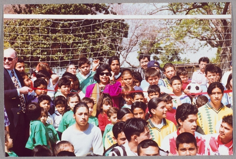 Gloria standing among group of kids.