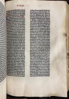 A page of a book printed with old English letters, featuring some larger accented and colored letters throughout.