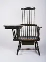 A green painted high back Windsor writing arm chair with a wooden paddle surface attached to the left arm of the chair as a writing surface; possibly by Ebenezer Tracy, Sr., Lisbon Township, New London County, Connecticut.