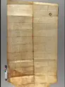 Long piece of parchment with written text and a dark crease down the middle. 