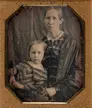 A framed black and white photo of a woman and young girl.