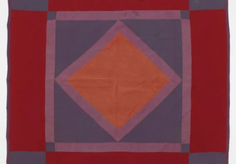 Amish quilt with rust diamond centered with purple border, on blue square with purple border, on wine red with blue squares at corners, dark purple binding; initials “R.S.” on verso.