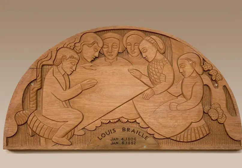 A mahogany wood art piece carved with people and shapes.
