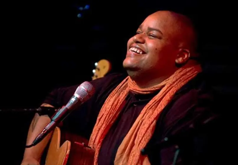 Portrait of Toshi Reagon playing guitar