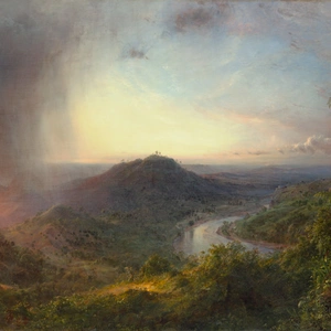 Wispy clouds partially obscure a golden sunrise or sunset; A mountain and river sit in the distance.