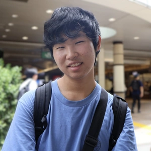 A smiling person in a blue shirt.