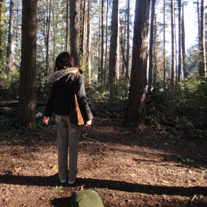 A person standing in a forest.