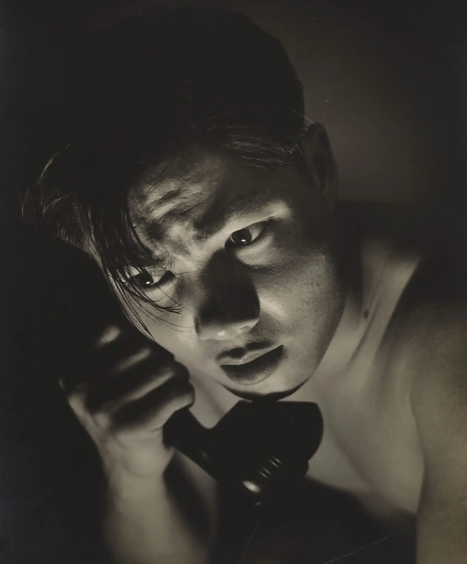 Black-and-white photograph of a person on the phone.
