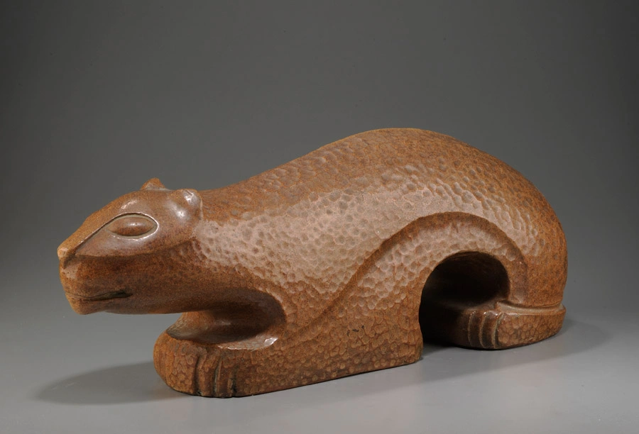 A crouching cat figurine.