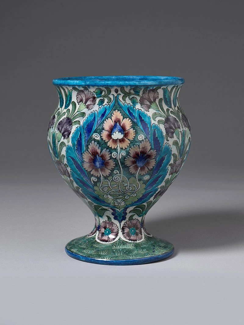 A beautifully detailed vase in blues, pinks, and greens.