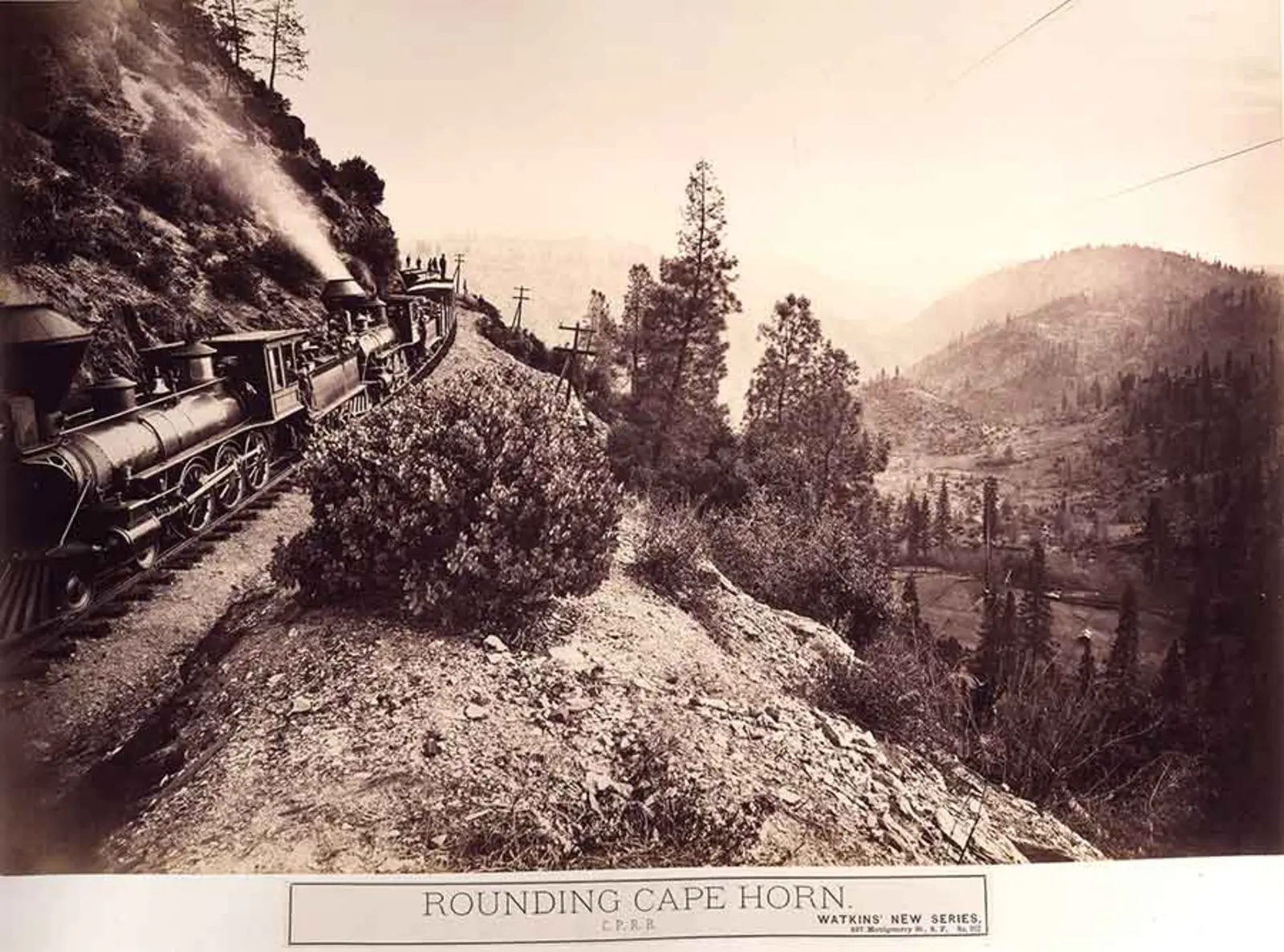 Sepia-tone photograph of a train on a hillside.