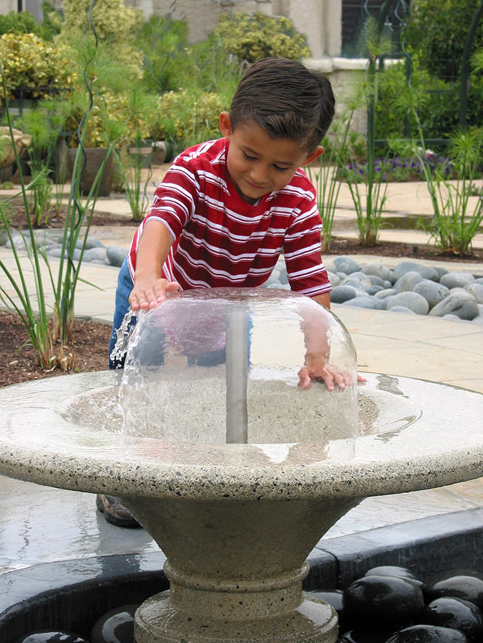 Water is one of four elements of nature represented in the interactive features in the Children’s Garden, along with Fire, Earth, and Air. Children can use their hands to change the shapes of water bells, thereby altering the flow of the water.