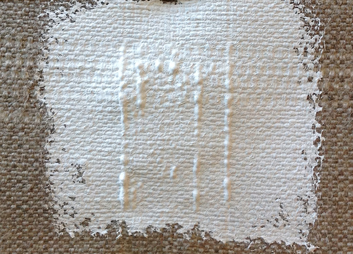 To illustrate her theory of a double-sided painting, the conservator applied white paint to the back of this canvas sample. The resulting texture gives credence to her theory.
