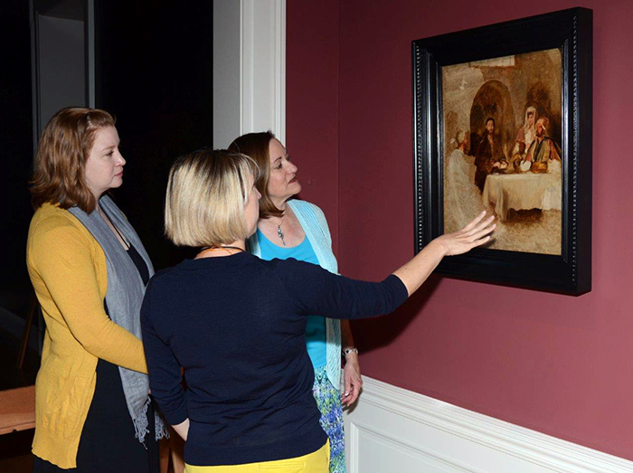 Tooey Durning (right) views the newly installed Supper at Emmaus at the Huntington Art Gallery with Melinda McCurdy (center), associate curator of British art, and Christina O’Connell (left), senior paintings conservator. Photograph by Lisa Blackburn.