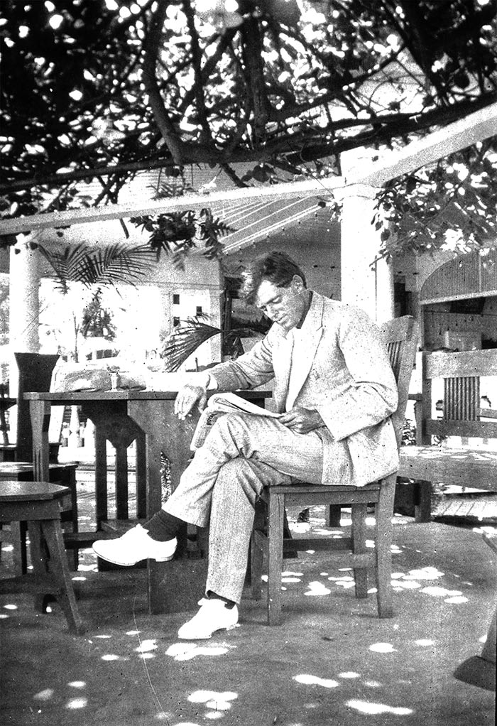 Jack London reads a newspaper to keep abreast of current events and glean ideas for new stories. The Huntington Library, Art Collections, and Botanical Gardens.