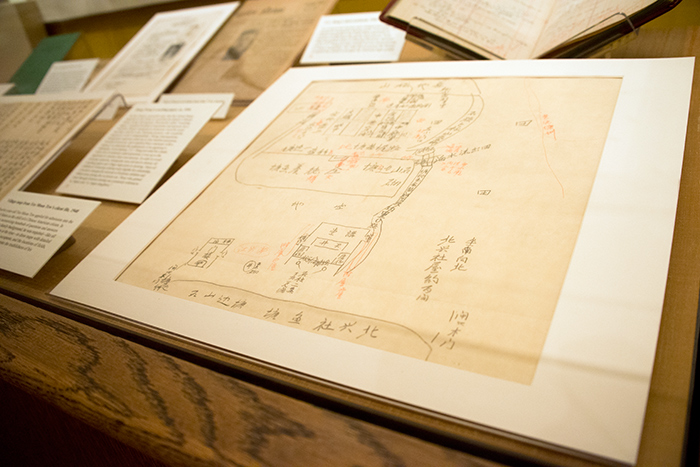 In one of the exhibition's display cases is a map produced by a 12-year-old boy showing a sketch of his home village in China. Immigration officials had the boy draw an annotated map and then used it to test relatives on who lived in each house. The Huntington Library, Art Collections, and Botanical Gardens.