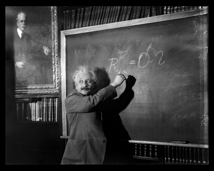 Albert Einstein at the blackboard during a talk, circa 1931, in the Mount Wilson Observatory's Hale Library, Pasadena, California. The Huntington Library, Art Collections, and Botanical Gardens.