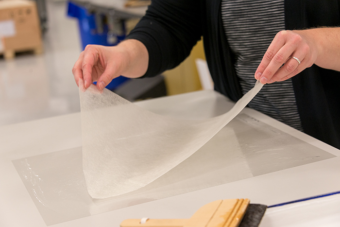Solvent set tissue is made by applying a special adhesive on a piece of thin polyester, dropping a lightweight piece of Japanese paper on top, and then waiting for it to dry. Photo by Kate Lain.