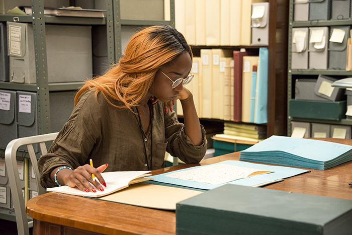 Jheanelle Garriques reads 18th-century letters in the Elizabeth Montagu archive at The Huntington as part of her research. Photo by Kate Lain.