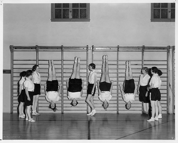 Girls turned head-over-heels for fitness in this photograph promoting the YWCA’s Business Girls’ Club gym class, ca. 1930s.