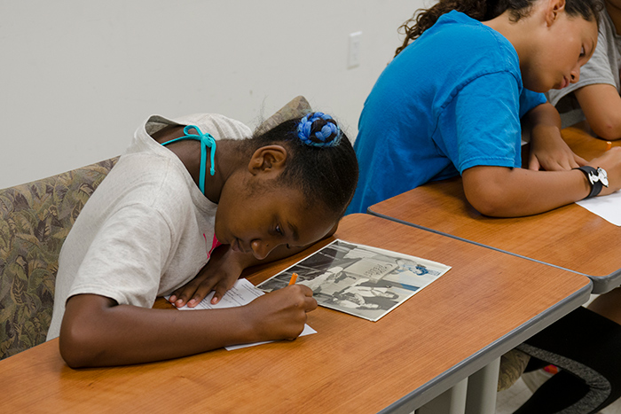 YWCA campers got a chance to act as curators themselves, writing sample label text for a selection of historical photos of earlier YWCA programs.