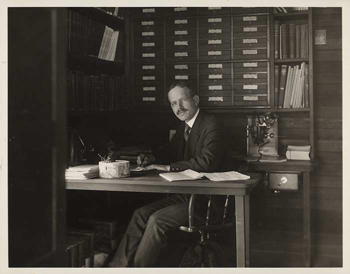Solar astronomer George Ellery Hale (1868–1938), ca. 1905, seated at his office desk in the Monastery at Mount Wilson Observatory, which he founded. Unidentified photographer. Image courtesy of the Observatories of the Carnegie Institution for Science Collection at The Huntington Library, Art Collections, and Botanical Gardens.