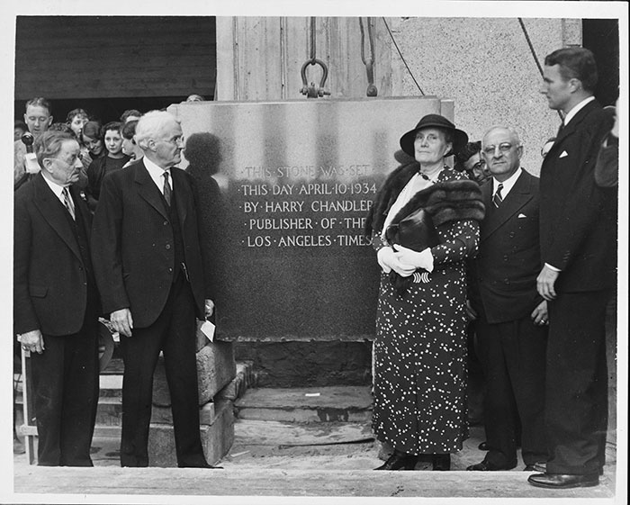 Pictured from left to right: F. X. Pfaffinger, Times publisher Harry Chandler, Marian Otis Chandler (wife of Harry Chandler and daughter of Harrison Gray Otis, the paper’s first chief editor), Jacob Baum, and Norman Chandler (son of Harry and Marian Otis Chandler) posing at the laying of the cornerstone for the fourth Los Angeles Times building, April 10, 1934. Los Angeles Times Records, 1869–2002. The Huntington Library, Art Collections, and Botanical Gardens.