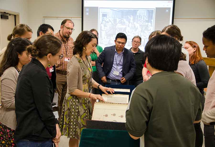 Participants in The Huntington’s first residential summer institute in the history of science, technology, and medicine gather around Daniela Bleichmar, professor of art history and history at the University of Southern California, to take a close look at some of the Library’s visual resources regarding natural history and Latin America. Photo by Lisa Blackburn.