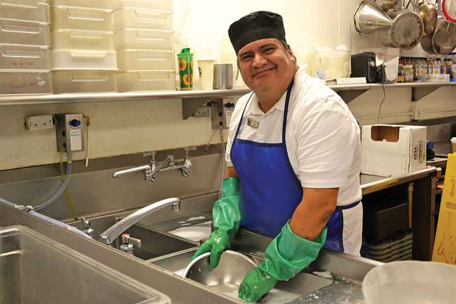 Mario Ahumada in his element, enjoying the bustling atmosphere of the kitchen. Photo by Lindsey Harrison. Courtesy of Villa Esperanza Services.