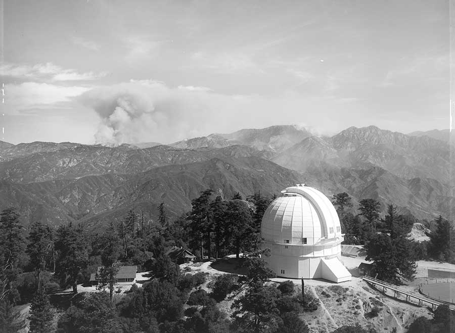 Forest fire in the west fork of the San Gabriel River, as seen from Mount Wilson Observatory, Sept. 29, 1924, around 10:20 a.m. Unknown photographer. The dome of the 100-inch Hooker Telescope is in the foreground. Image courtesy of the Observatories of the Carnegie Institution for Science Collection at the Huntington Library.